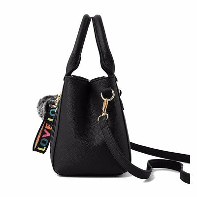 Black handbag with colorful 'LOVE' detail on a white background