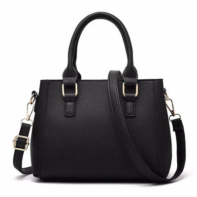 Black handbag with gold hardware on a white background
