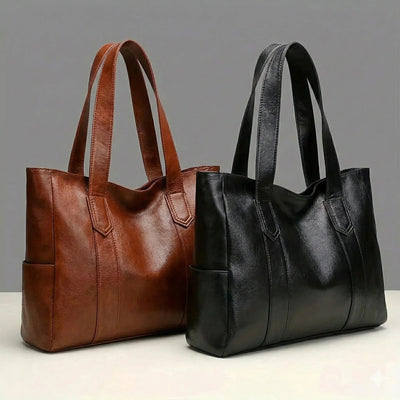 Brown and black leather handbags on a gray background